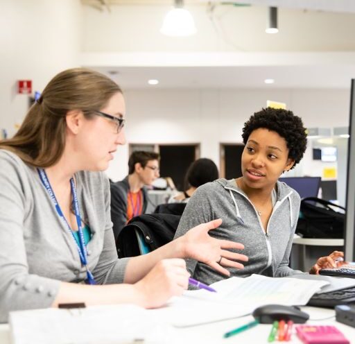 A tutor works with a student in the ACCelerator learning space at ACC.