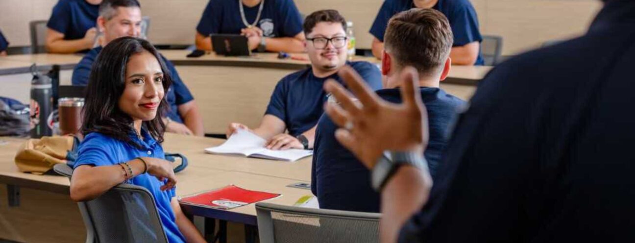 A classroom scene featuring ACC criminal justice students attentively sitting at desks, participating in a learning environment.
